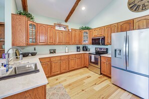 A modern kitchen with wooden cabinets, stainless steel appliances, and a marble countertop. - 3 Mi to Dtwn: Mtn-View Red Lodge Retreat! (Red Lodge)