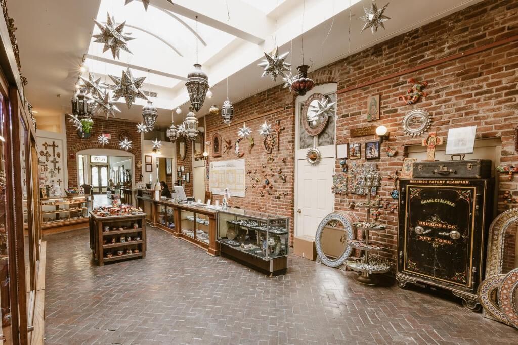 A spacious boutique with brick walls, various decorative items, and a display counter.