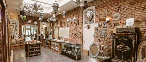 A spacious boutique with brick walls, various decorative items, and a display counter.