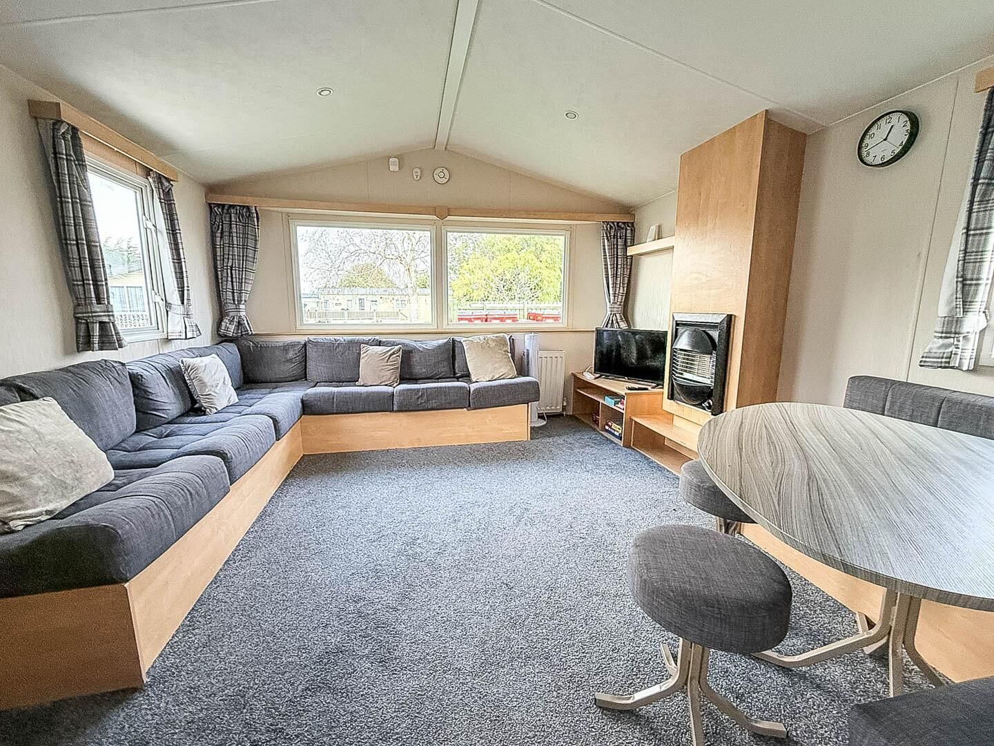 Spacious living room with panoramic windows and cozy seating