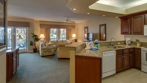 A modern kitchen with a central island, built-in cabinets, and a dining area with a sofa. - 2 Bedroom Villa--Free Golf, Tennis--Pools, Beach and the Fabulous Westin!! (Hilton Head Island)