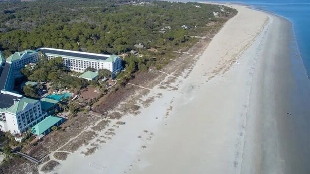An aerial view of a coastal hotel with a long beachfront, dense forested area, and a large building with multiple structures. - 2 Bedroom Villa--Free Golf, Tennis--Pools, Beach and the Fabulous Westin!! (Hilton Head Island)