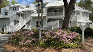 A large, multi-story building with a white exterior, multiple balconies, and a prominent staircase. - 2 Bedroom Villa--Free Golf, Tennis--Pools, Beach and the Fabulous Westin!! (Hilton Head Island)