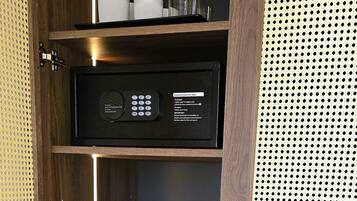 A kitchenette with a coffee maker, a kettle, and a coffee pod dispenser.