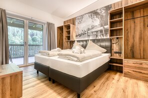 Relax in a serene space with a large bed, nightstand, and shelving units.