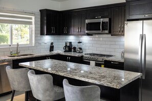 Fridge, stovetop, dishwasher, coffee/tea maker