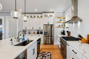 A modern kitchen with white cabinetry, stainless steel appliances, and pendant lighting. - Lakefront Lake Anna, Boat Dock, Deck Views (Mineral)