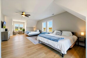 A bedroom with two beds, a ceiling fan, and a view of the outdoors. - Lakefront Lake Anna, Boat Dock, Deck Views (Mineral)