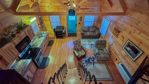 A wooden cabin interior with a kitchen, living area, and a staircase. - Lazy Lake Days • Fast Wifi • Roku TV • Free Firewood (Alpine)