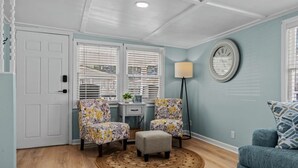 A room with two armchairs, a small table, a lamp, and a round rug. - Ocean Lakes Cottage, Covered Patio, Grill and Beach! (Myrtle Beach)
