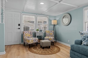 A room with two armchairs, a small table, a lamp, and a round rug. - Ocean Lakes Cottage, Covered Patio, Grill and Beach! (Myrtle Beach)
