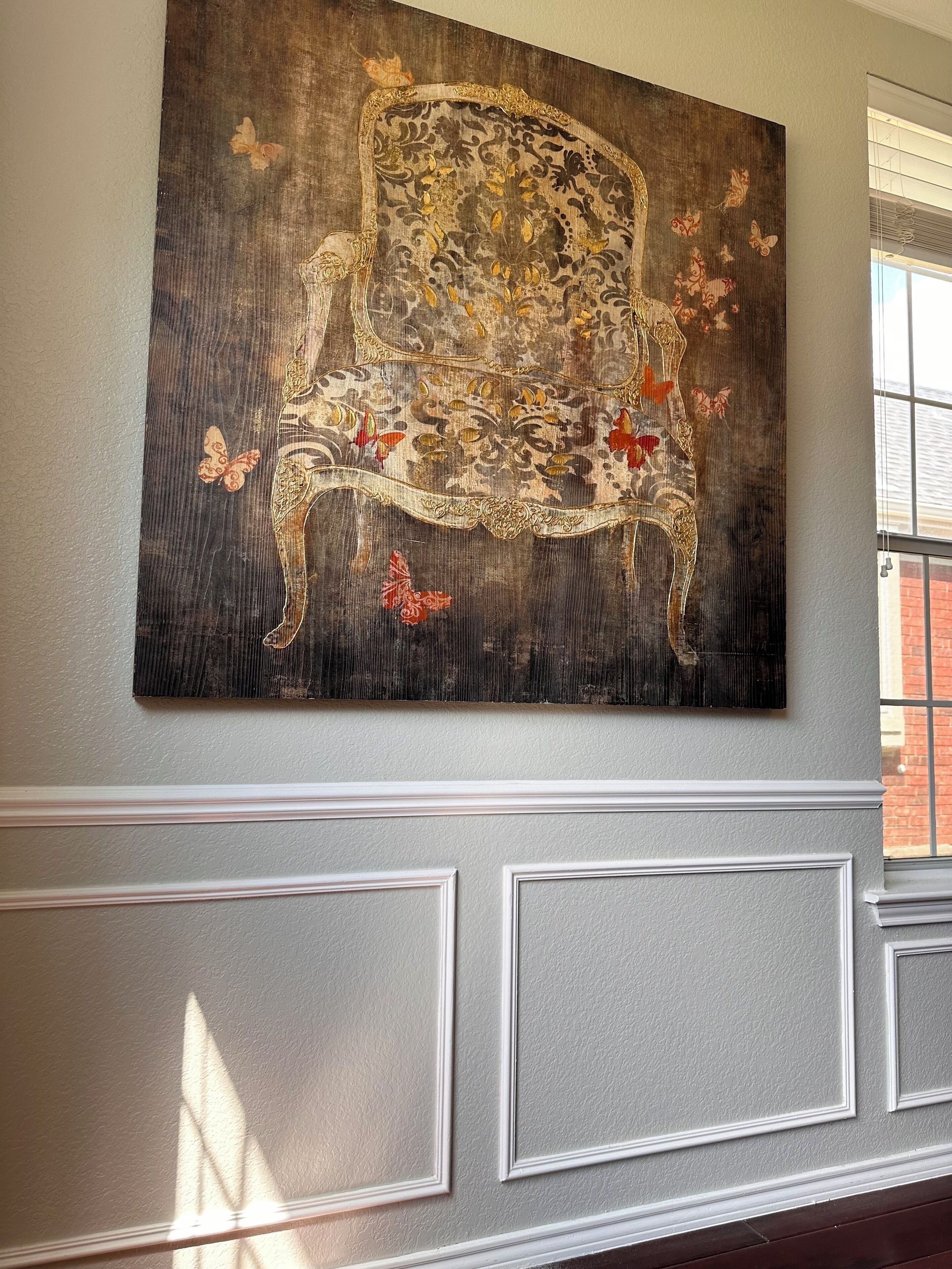 A wall with a large, ornate chair artwork and a window with blinds.