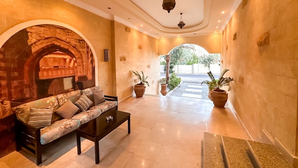 A spacious lobby with a sofa, coffee table, and potted plants. - Fully furnished 02 BR with sea view roof top (Hurghada)