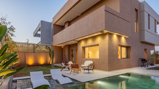 A modern two-story house with a swimming pool, outdoor seating, and a well-lit patio area. - Villa Yas - 5-Stars - Heated Pool - Driver - Chef - Games - 15min to City Center (Marrakech)