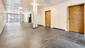 A spacious corridor with wooden walls and floors, large windows, and a staircase. - Luxus Penthouse Zentral (Brand)