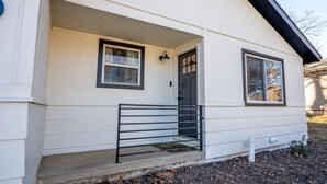 A single-story house with a front porch, a door, and two windows. - Main Retreat w/ King Bed in Master, and has Garage (Springfield)