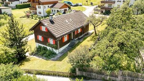 A residential area with houses, a pathway, and a small fenced area. - Chalet Mariedl in Tschagguns (Tschagguns)