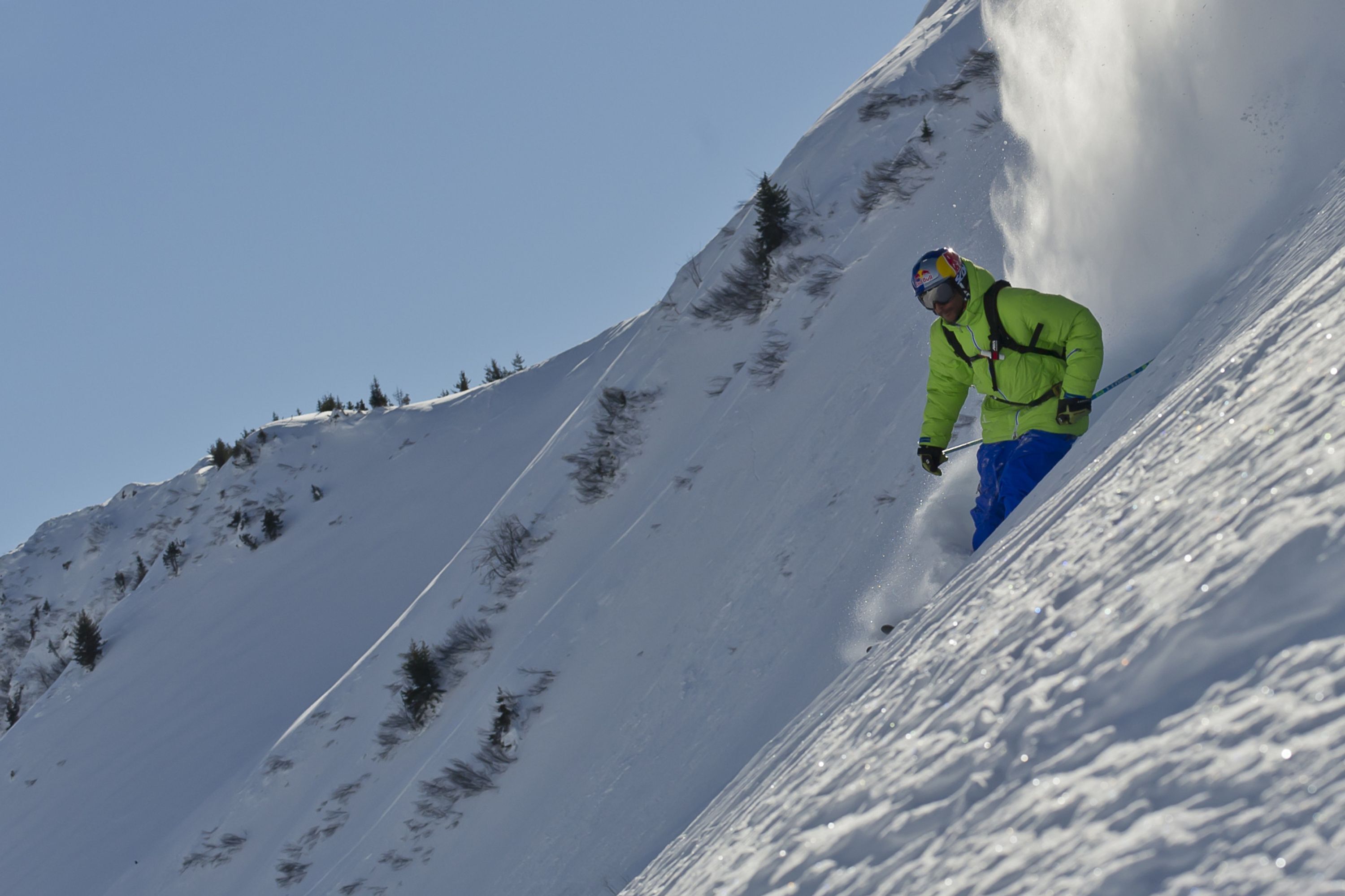 A person skiing down a snow-covered slope.