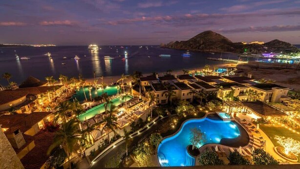 A resort with multiple swimming pools, beachfront villas, and a view of the sea at night. - Luxury  Oceanfront Condo with Private Plunge Pool (Cabo San Lucas)