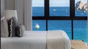 A bed with a view of the sea and boats. - Luxury  Oceanfront Condo with Private Plunge Pool (Cabo San Lucas)