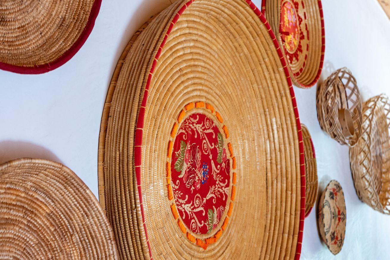 A close-up of woven baskets with a central red patterned design.