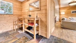 Un interno in legno con un armadietto, uno specchio, una mappa e un letto.
