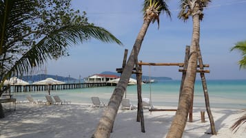 On the beach, white sand, sun-loungers