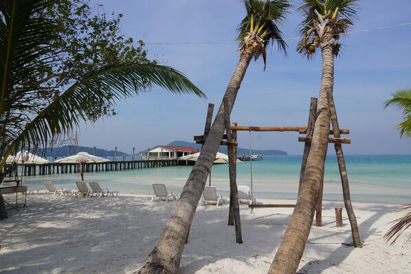 On the beach, white sand, sun loungers