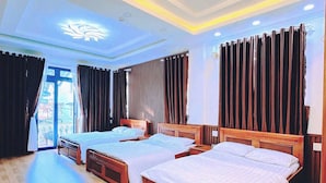 A hotel room with two beds, a large window, and a ceiling with decorative lighting. - Hostel Nha Tho (Lam Vien - Da Lat)