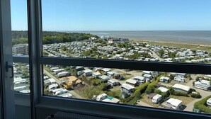 A view of a caravan park with multiple caravans and a beach in the background. - FB12.06 - Apartment for 2 persons with sea view, swimming pool and sauna - (Cuxhaven)