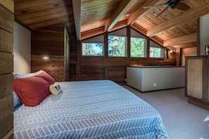 A cozy cabin room with a bed, a small kitchenette, and large windows. - Majestic Pines Tahoe City (Tahoe City)