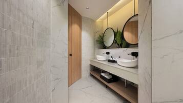 Un baño moderno con piso de mármol, puerta de madera y tocador con dos lavamanos y un espejo.