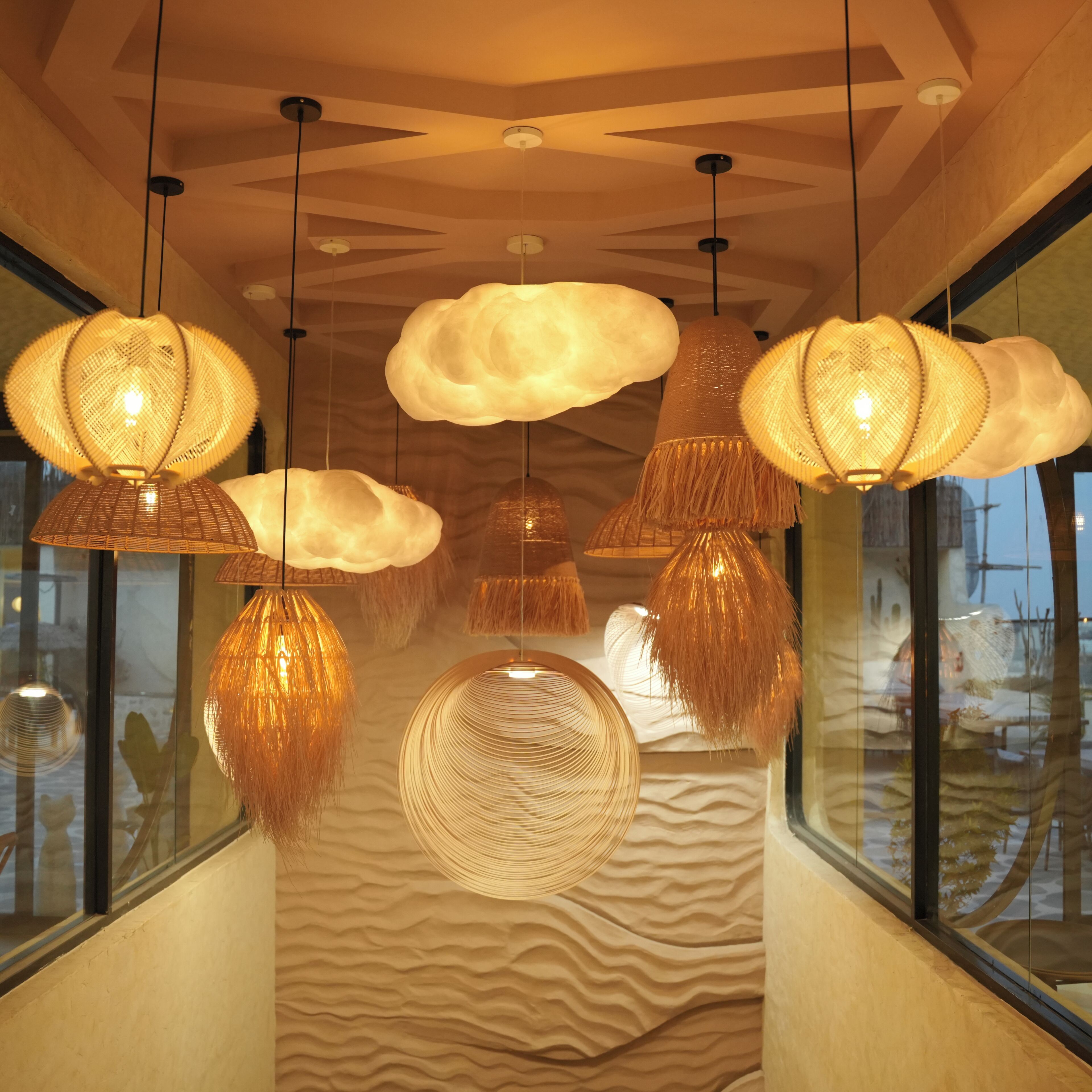 A corridor with hanging lamps and a textured wall.