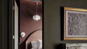 A modern bedroom with a large bed, a fireplace, and a framed artwork on the wall. - Dreamy Condo with Fireplace, Rooftop, Gym, Parking  |  Sleeps 5 w/ King Bed, Sleeper Sofa, Hidden Bunk, Shared Rooftop and Gym, Free Dedicated Parking, Minutes to Broadway, Five Points & Grand Ole Opry, 24 Hr Hospitality (Nashville)