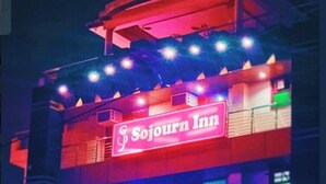 A building with a prominent 'Sojourn Inn' sign. - Sojourn Inn (Lucknow)