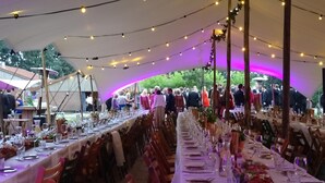 A tented outdoor dining area with tables set for a meal, surrounded by chairs. - Pean Huur je Eigen Schier Eiland (Nes)