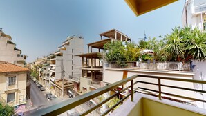 A multi-story residential building with balconies, some with plants. - OneZeroTwo by Zoia Living (Athens)