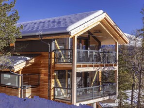 Experience the perfect blend of rustic charm and modern design in this cozy cabin, featuring a spacious balcony and large windows.