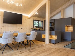 Enjoy meals at the dining table with a flat-screen TV above, and take in the view from the kitchen window.