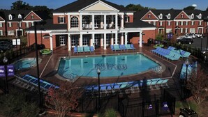 A hotel with a large pool area, a covered patio, and a classic architectural style. - New House! Close to HPU & HPMKT (High Point)