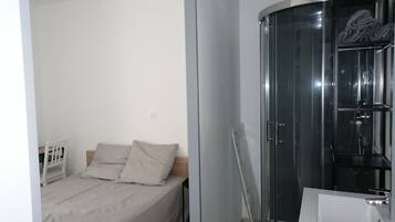 1 bedroom, desk, iron/ironing board, travel crib