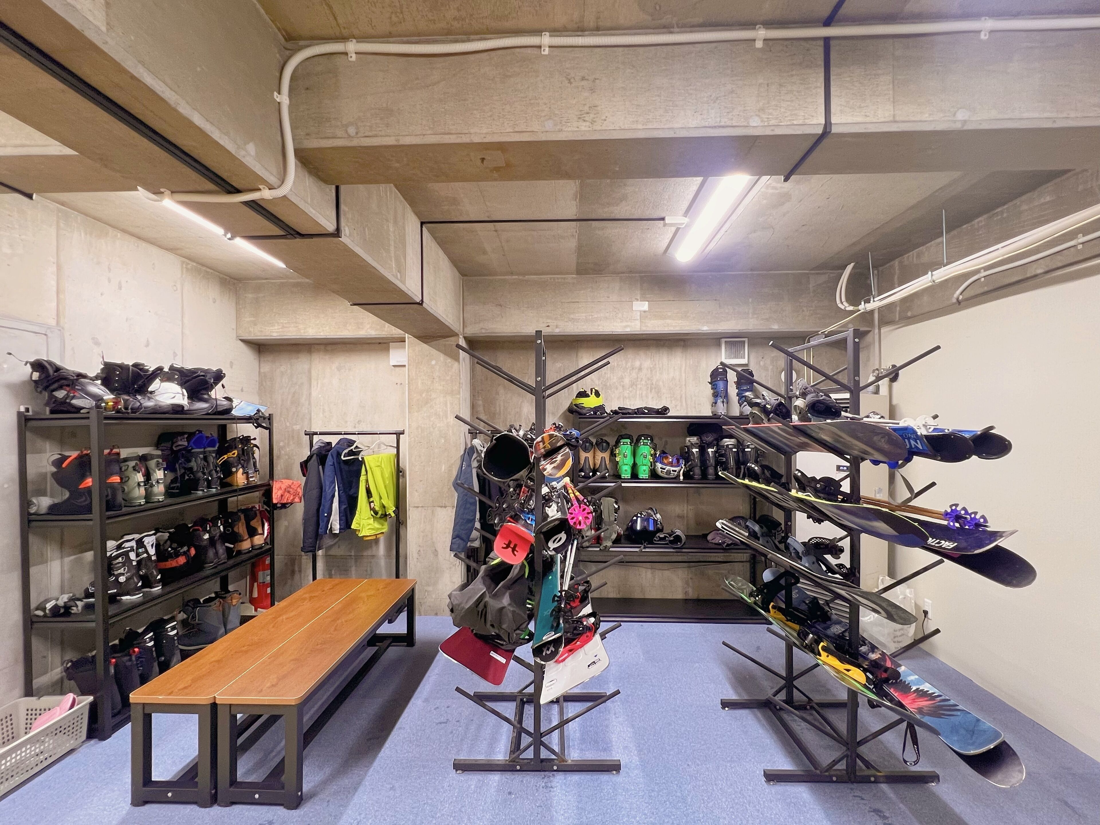 A storage room with shelves for shoes and a bench.