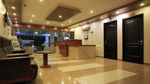 A hotel lobby with a reception desk, a reception area, and two black doors labeled "Office". - Philomena Hotel & Apartment (Thanjavur)