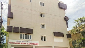 A multi-story building with a sign for 'PHILOMENA HOTEL & APARTMENT'. - Philomena Hotel & Apartment (Thanjavur)