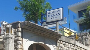 A stone wall with a large arched entrance and a sign above it. - Studio+free parking, 100m to sea (Crikvenica)