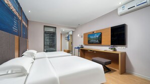 A modern hotel room with a large bed, a desk with a computer, and a TV mounted on the wall. - Stay at Guilin Downtown (Guilin)