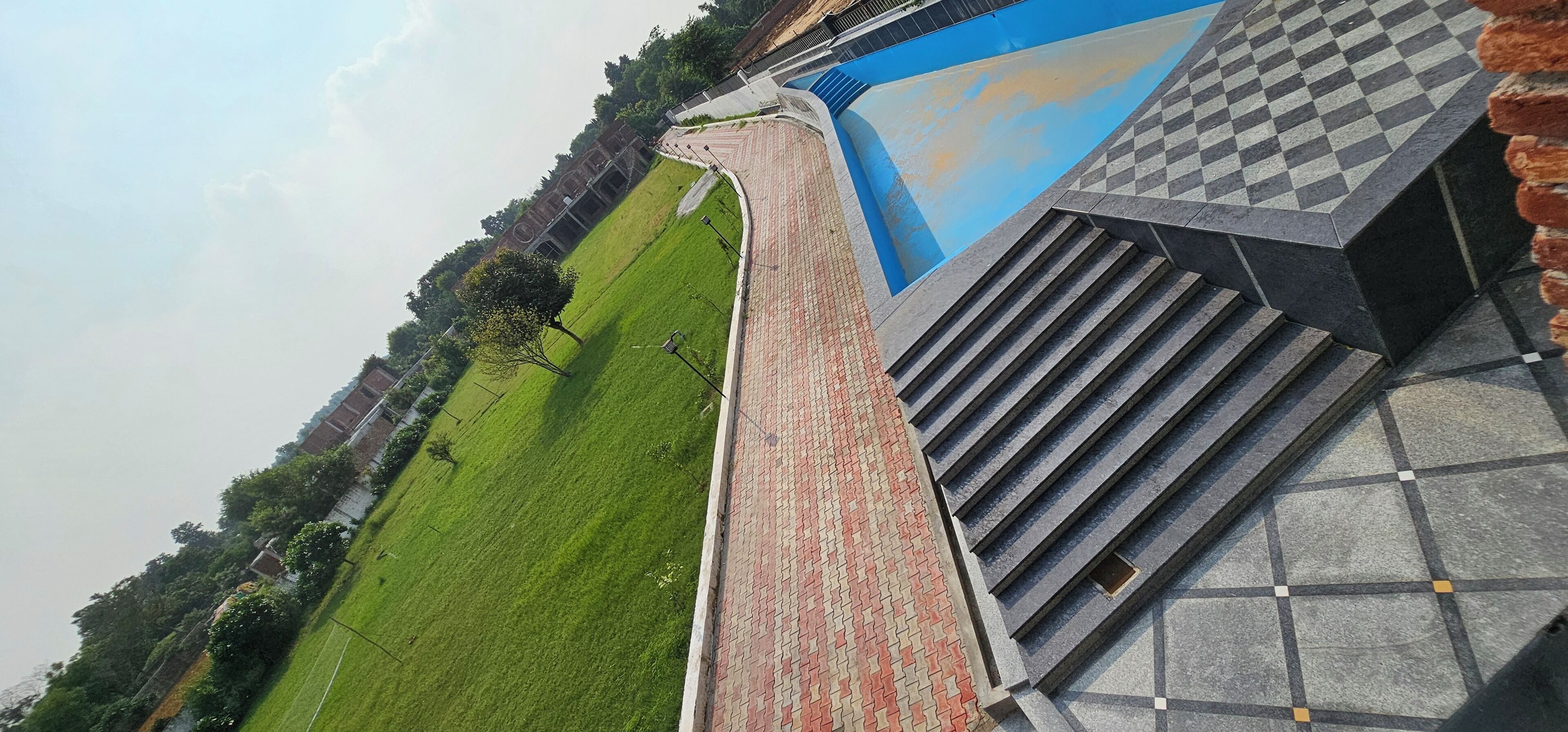 A building with a sloped roof and a checkered pattern on the exterior wall.