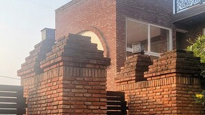 A brick structure with a sign reading "Ayaansh Resort". - Ayaansh Resort (Sohna)