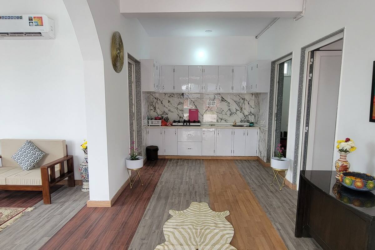 A modern living room with a sofa, a coffee table, and a patterned rug.
