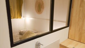 A bathroom with a mirror, a towel rack, and a wooden cabinet.
